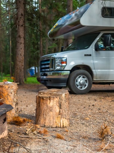 campfire-burning-brightly-next-to-rv-in-campsite